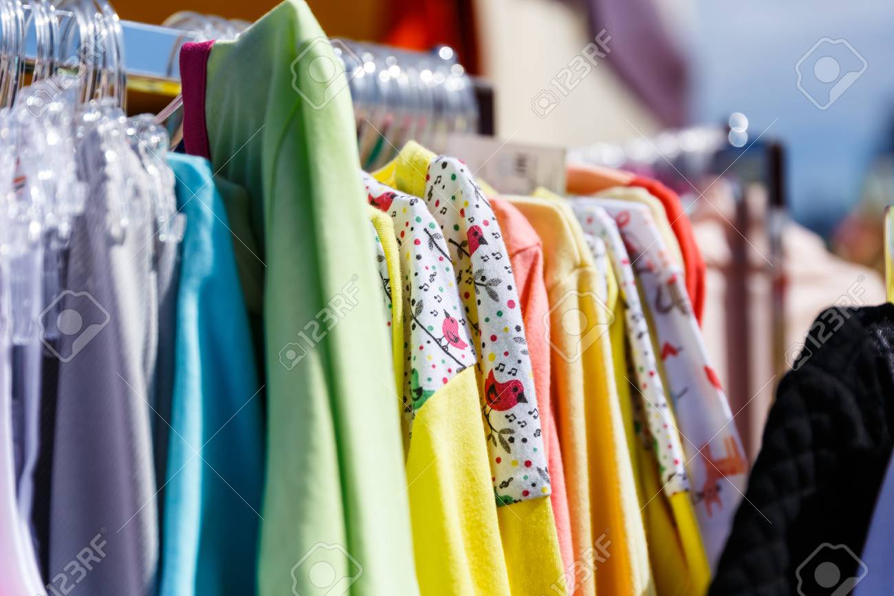 baby clothes pants t shirts sweaters shirts hanging on hangers