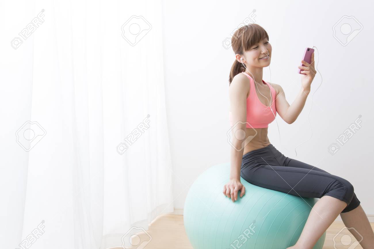 バランス ボールで音楽を聞く女性 の写真素材 画像素材 Image
