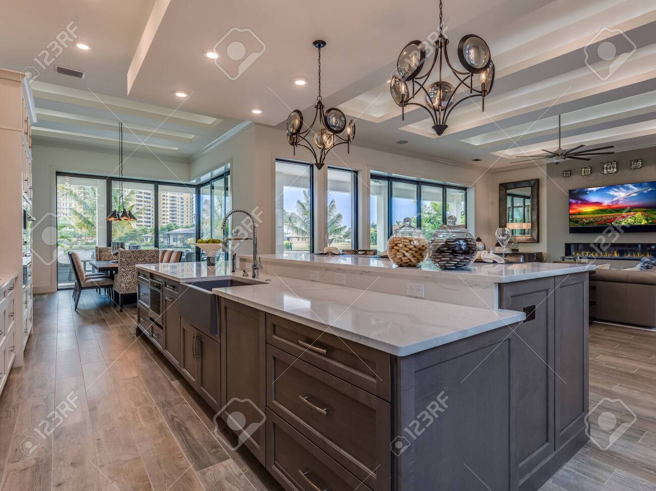 Large Island In White Kitchen With A Lot Of Windows With A View Stock  Photo, Picture and Royalty Free Image. Image 145042893., image size:1300x974