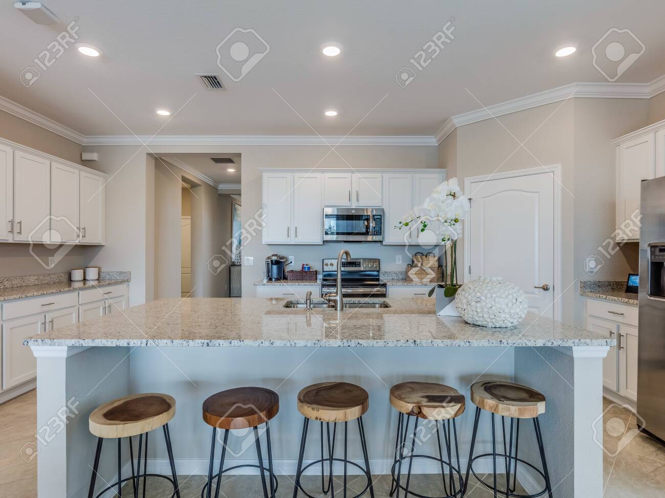 White Kitchen Island With Seating For Five People Stock Photo Picture And Royalty Free Image Image 144110638
