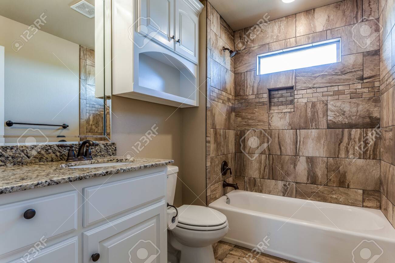 Nicely Designed Bathroom With Small Linear Window In Shower Stock Photo