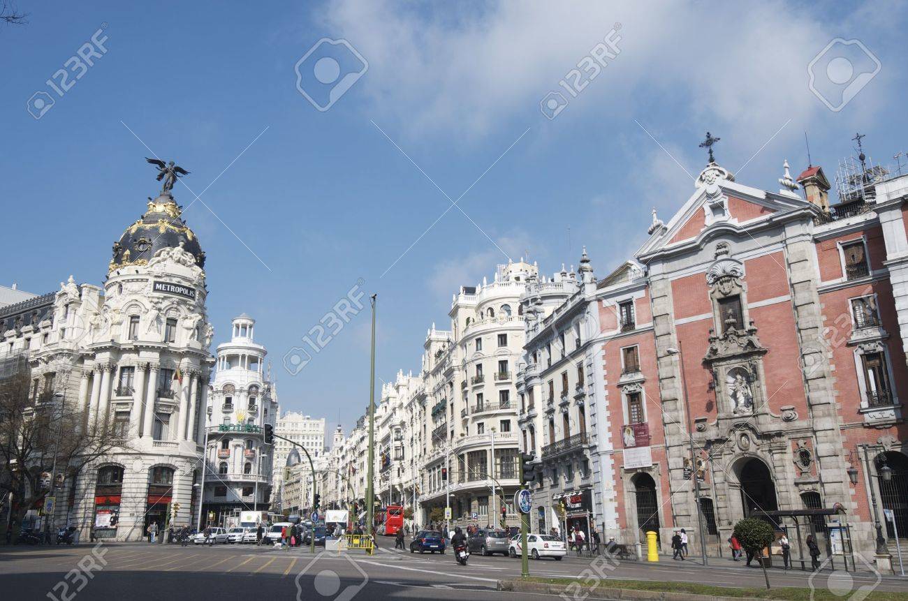 Madrid, Spain - March 22, 2012: A view of the street known as Gran Via, one of the busiest streets of the city and traveled daily by thousands of tourists. From the buildings stands the building known as Metropolis - 14597283 Madrid, Spain - March 22, 2012: A view of the street known as Gran Via, one of the busiest streets of the city and traveled daily by thousands of tourists. From the buildings stands the building known as Metropolis - 14597283