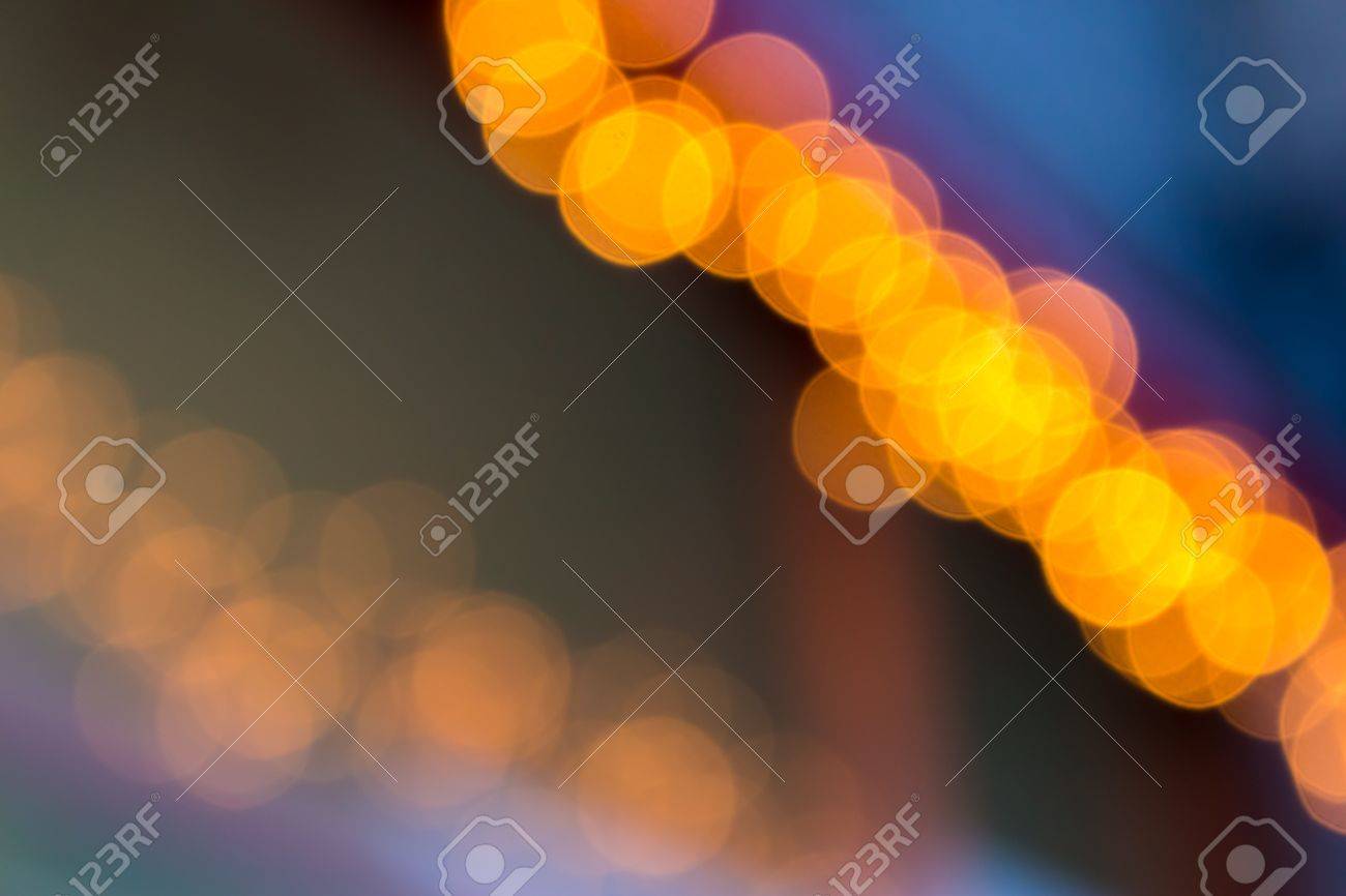 Abstract Background Of Blurred Warm Lights With Cool Blue And