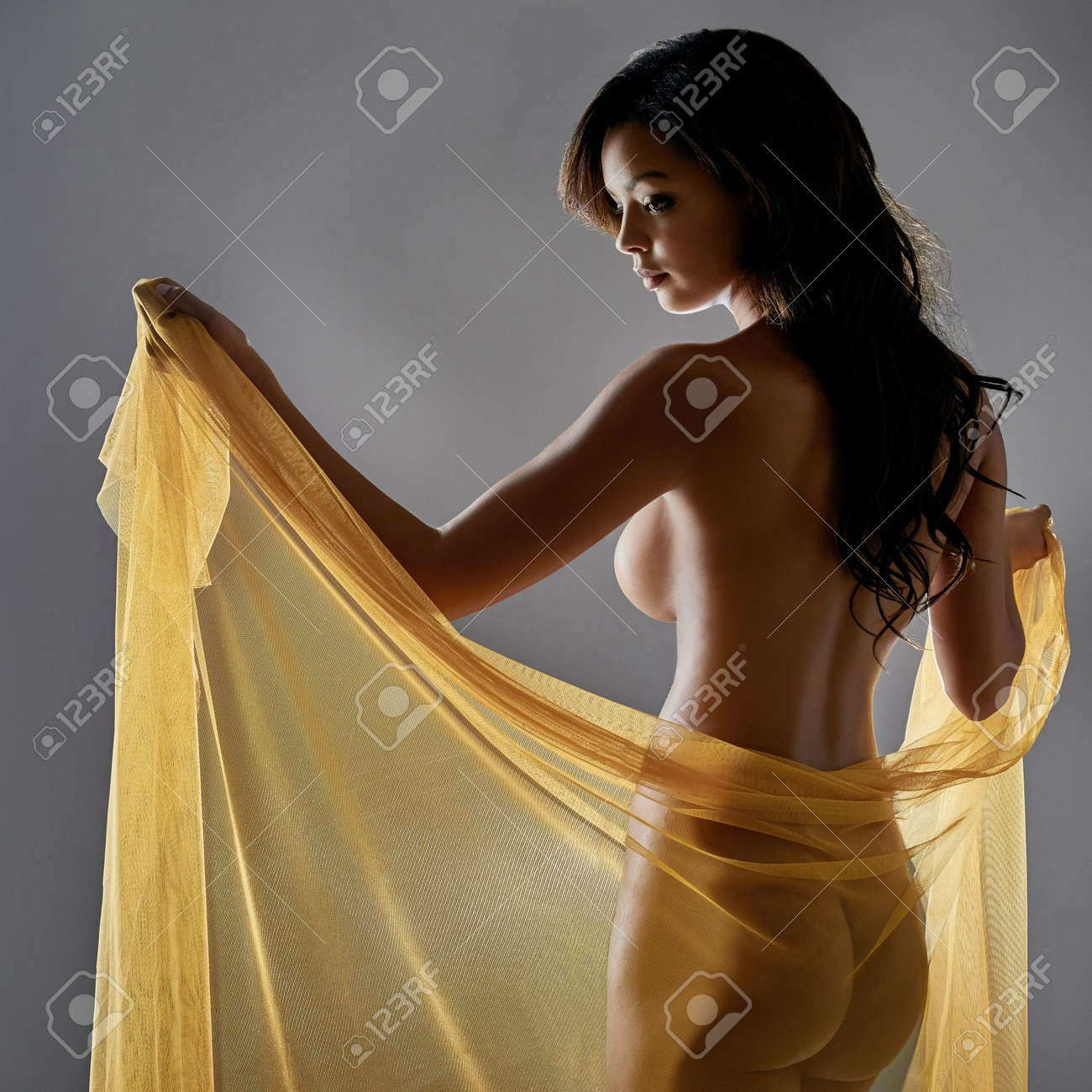 Her Beauty Is Truly Mesmerizing. Rearview Shot Of A Sexy Young Woman Posing  Nude With A Sarong Against A Grey Background. Stock Photo, Picture and  Royalty Free Image. Image 183939931.