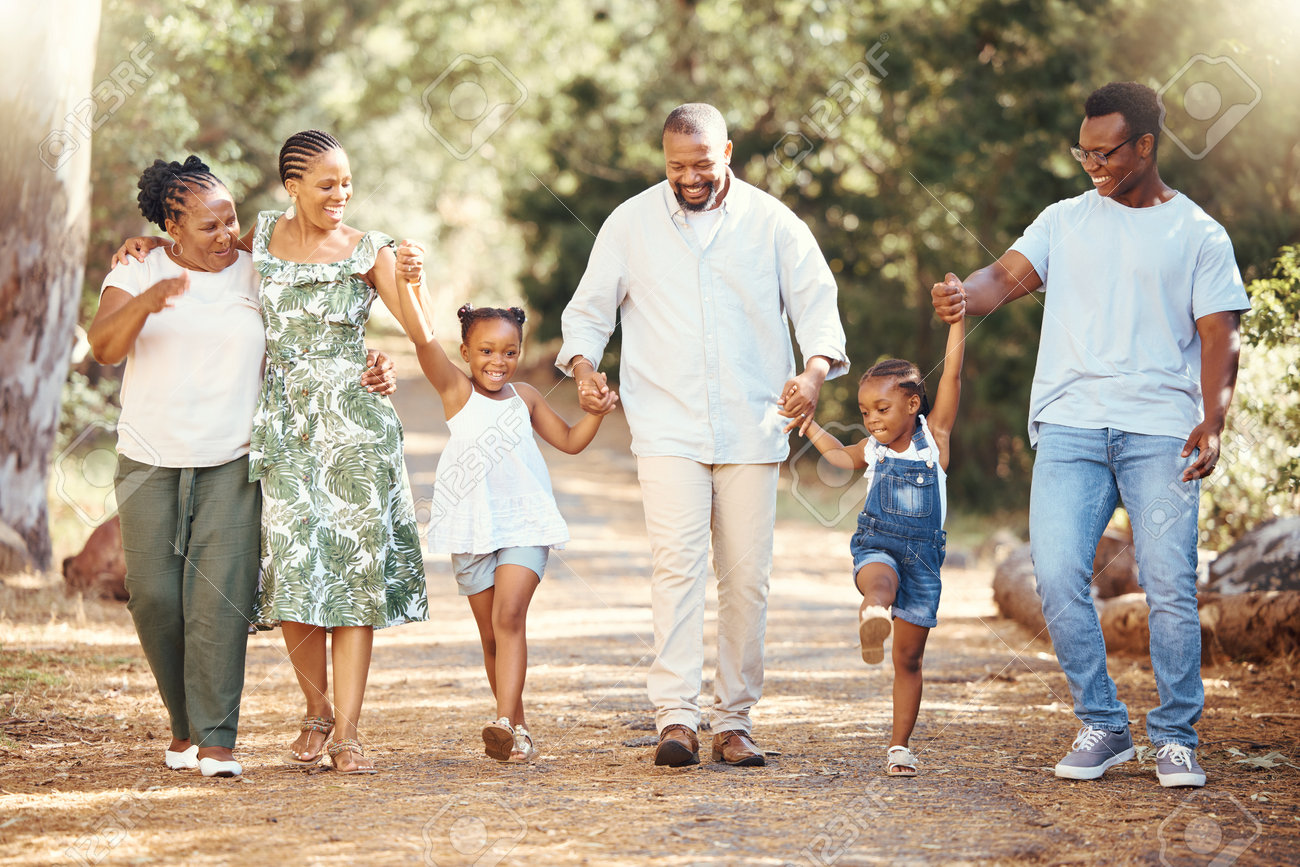 Black Family, Hiking Or Bond With Children, Parents Or Grandparents Walking  In Remote Nature Forest And Countryside. Happy Mother, Father Or Senior  Holding Hands With Girls And Skipping In Tree Park Stock, image size:1300x867
