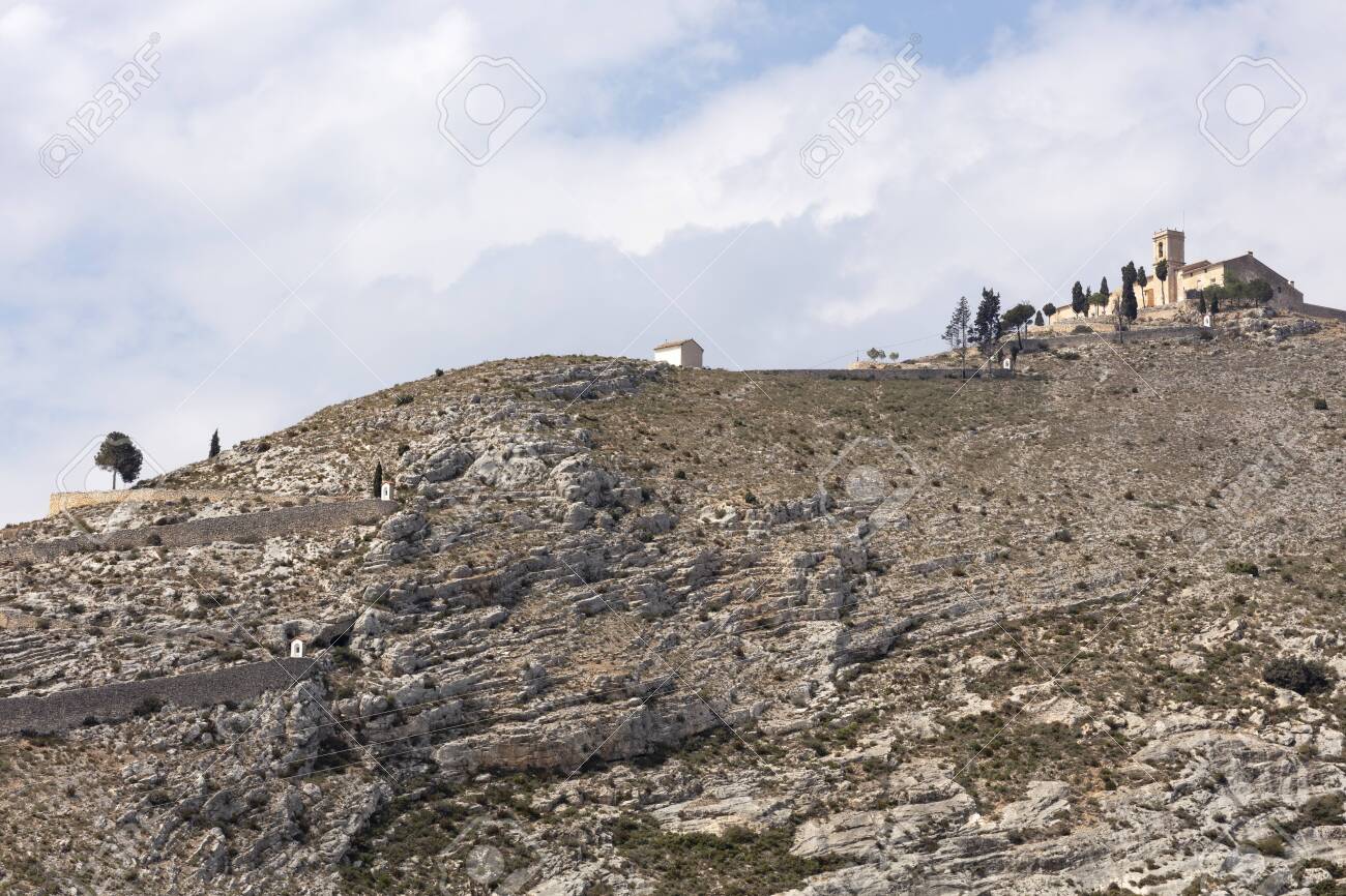 ermitage of saint christ on top of the hill in Bocairent, Spain with the pathway, the hill is rocky and the sky in the background is cloudy - 123523492 ermitage of saint christ on top of the hill in Bocairent, Spain with the pathway, the hill is rocky and the sky in the background is cloudy - 123523492