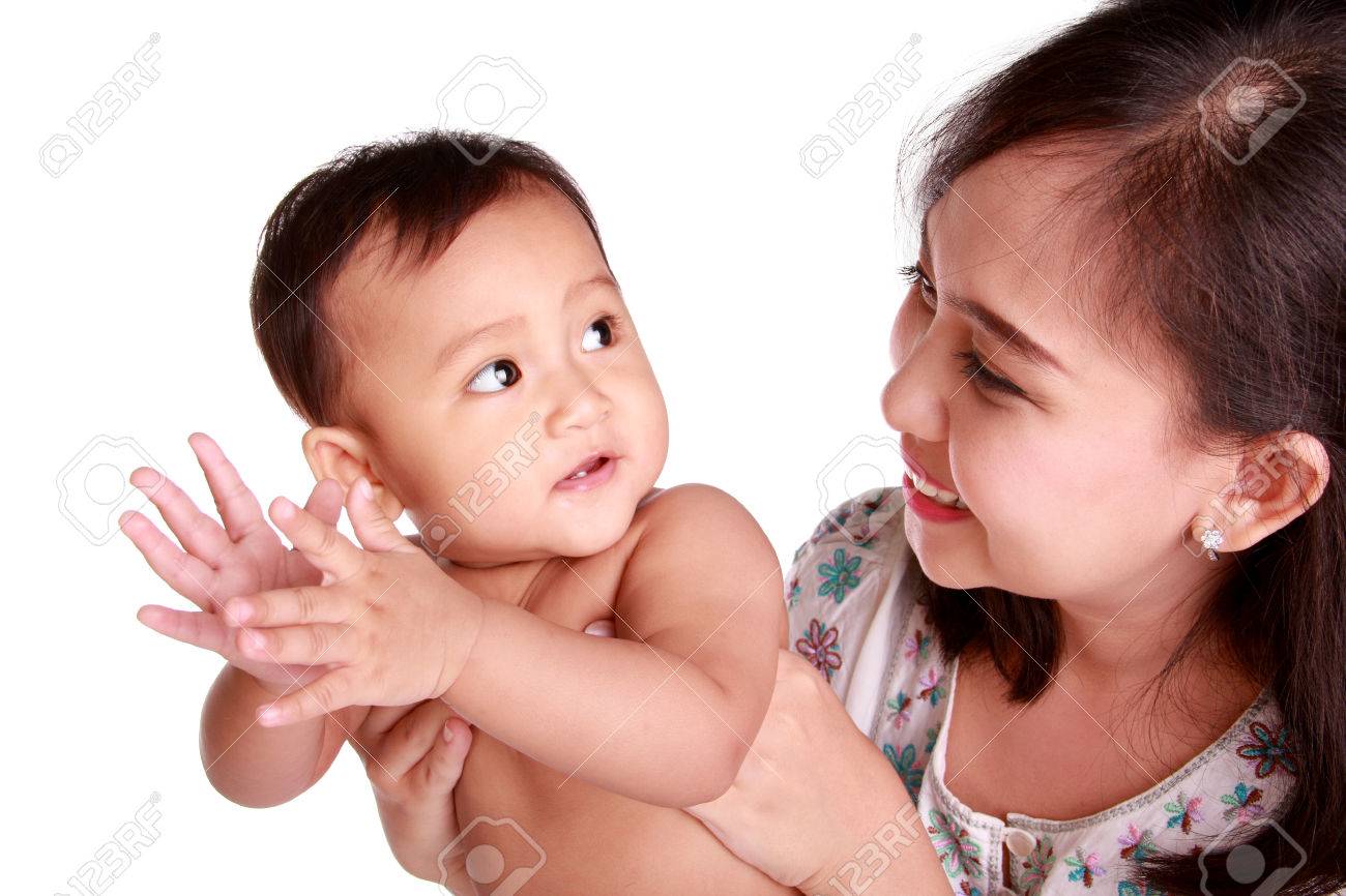 Cute Baby Girl Clapping Hands And Looking Back At Her Mom Isolated