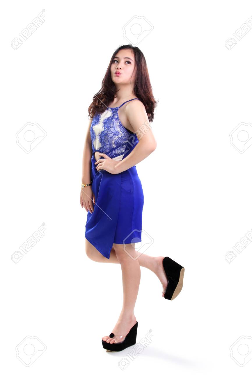 Full Body Shot Of Lovely Girl Walking In Stylish Blue Dress, Looking Up And  Making A Cute Duck Face, Isolated On White Background Фотография, картинки,  изображения и сток-фотография без роялти. Image 53431240