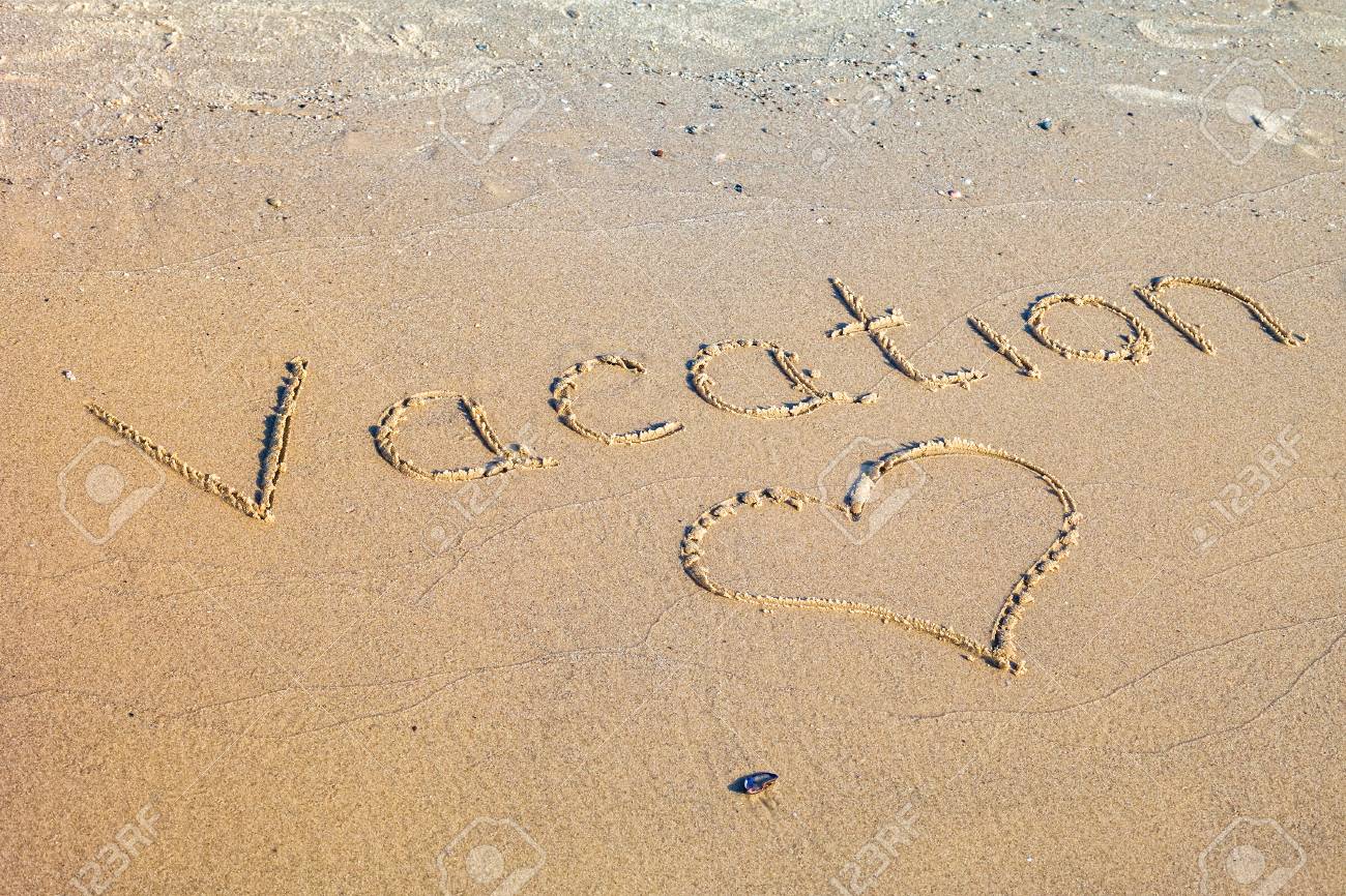 word vacation written in the sand on the beach stock photo picture