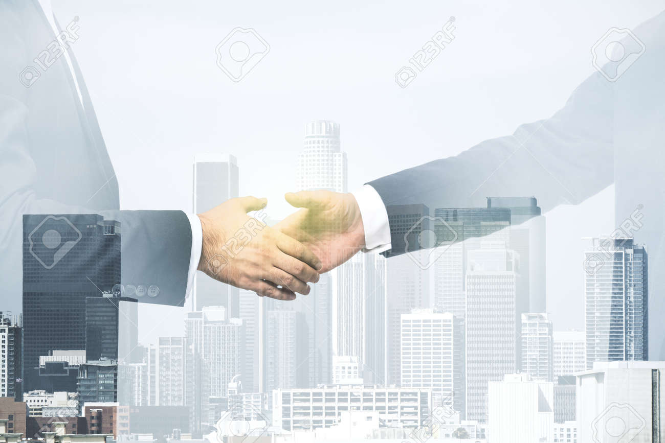 Double exposure of handshake two businessmen on modern skyscrapers background, research and strategy concept - 169781562 Double exposure of handshake two businessmen on modern skyscrapers background, research and strategy concept - 169781562