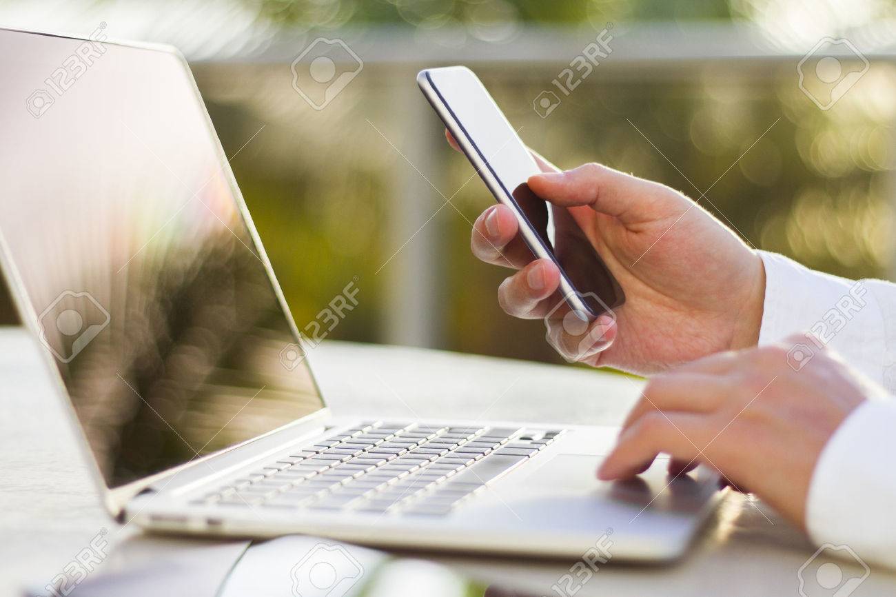 businessman with cellphone and laptop at morning - 43491351 businessman with cellphone and laptop at morning - 43491351