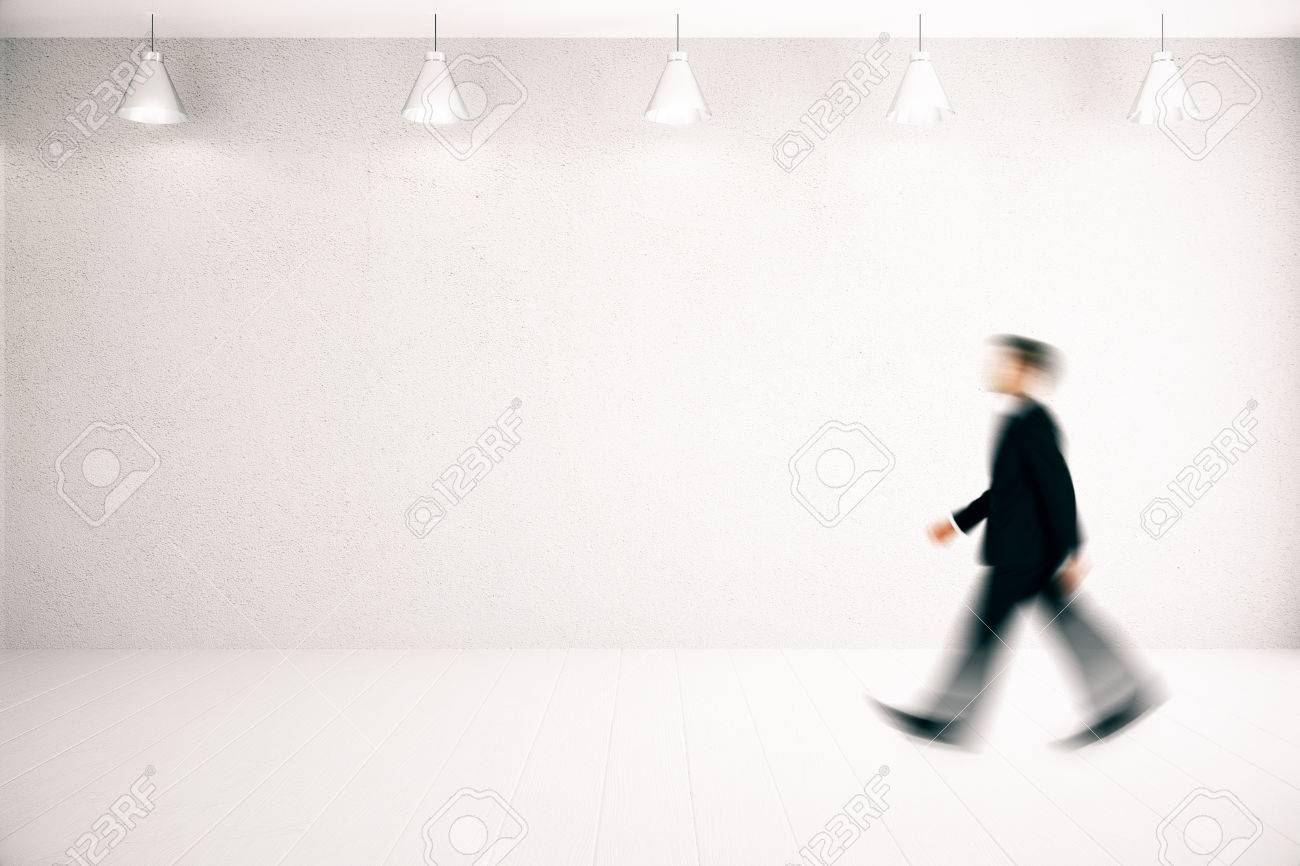 Side View Of Blurry Businessman Walking In Nfurnished Concrete