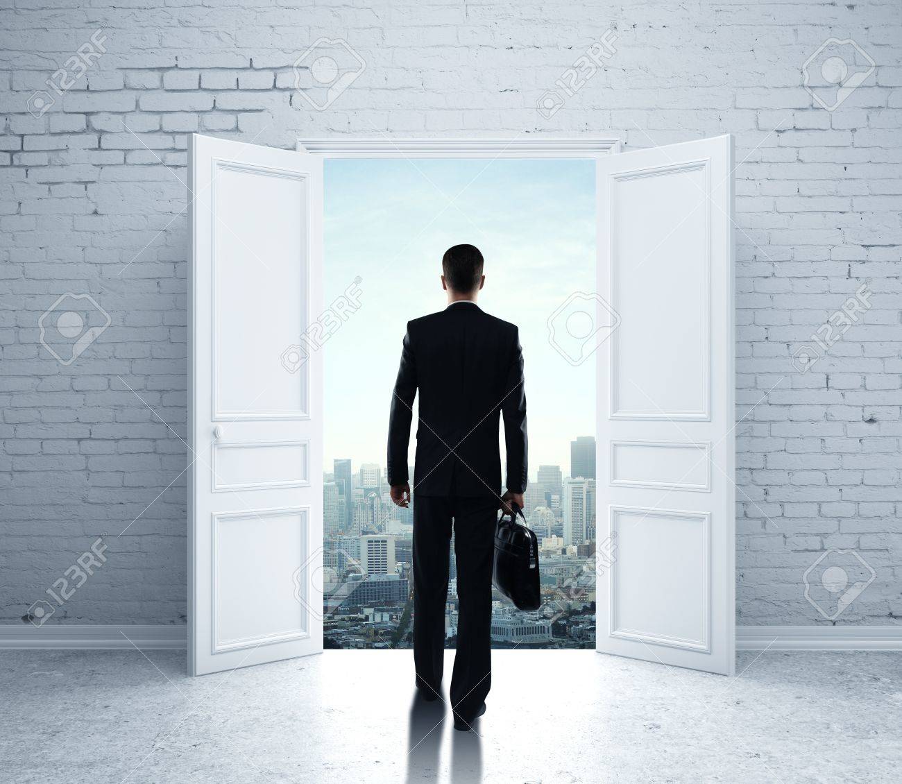 Businessman Walking In Open Door To City