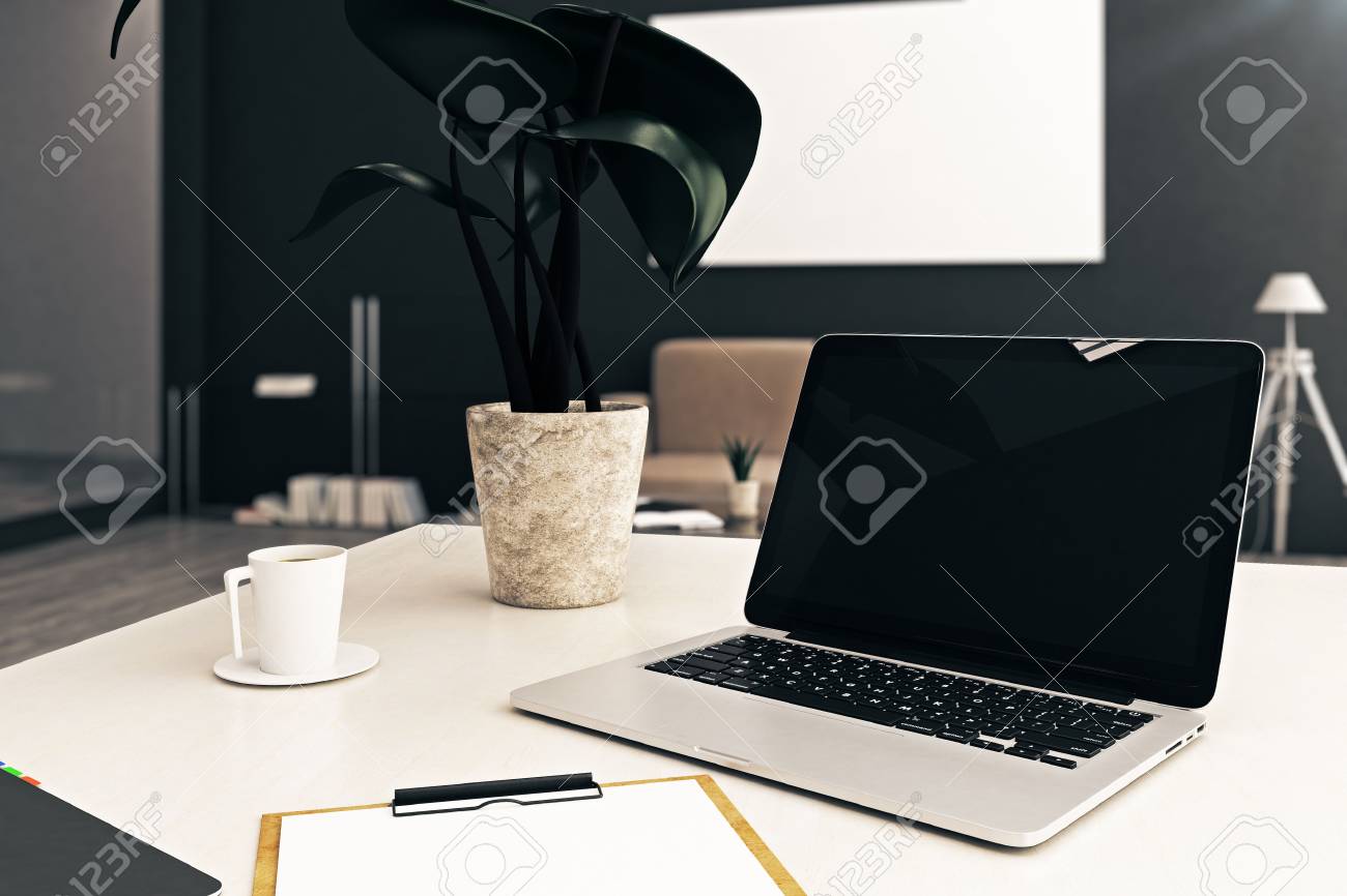 Close Up Of Empty Laptop Placed On Office Coffee Table With Plant