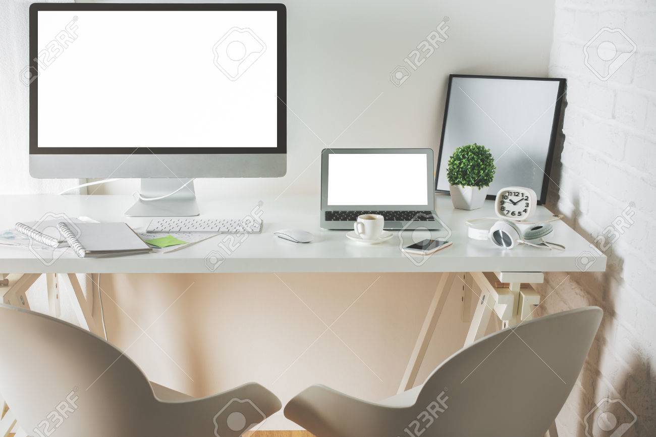 Front View Of Clean Office Desktop With Empty Computer And Laptop