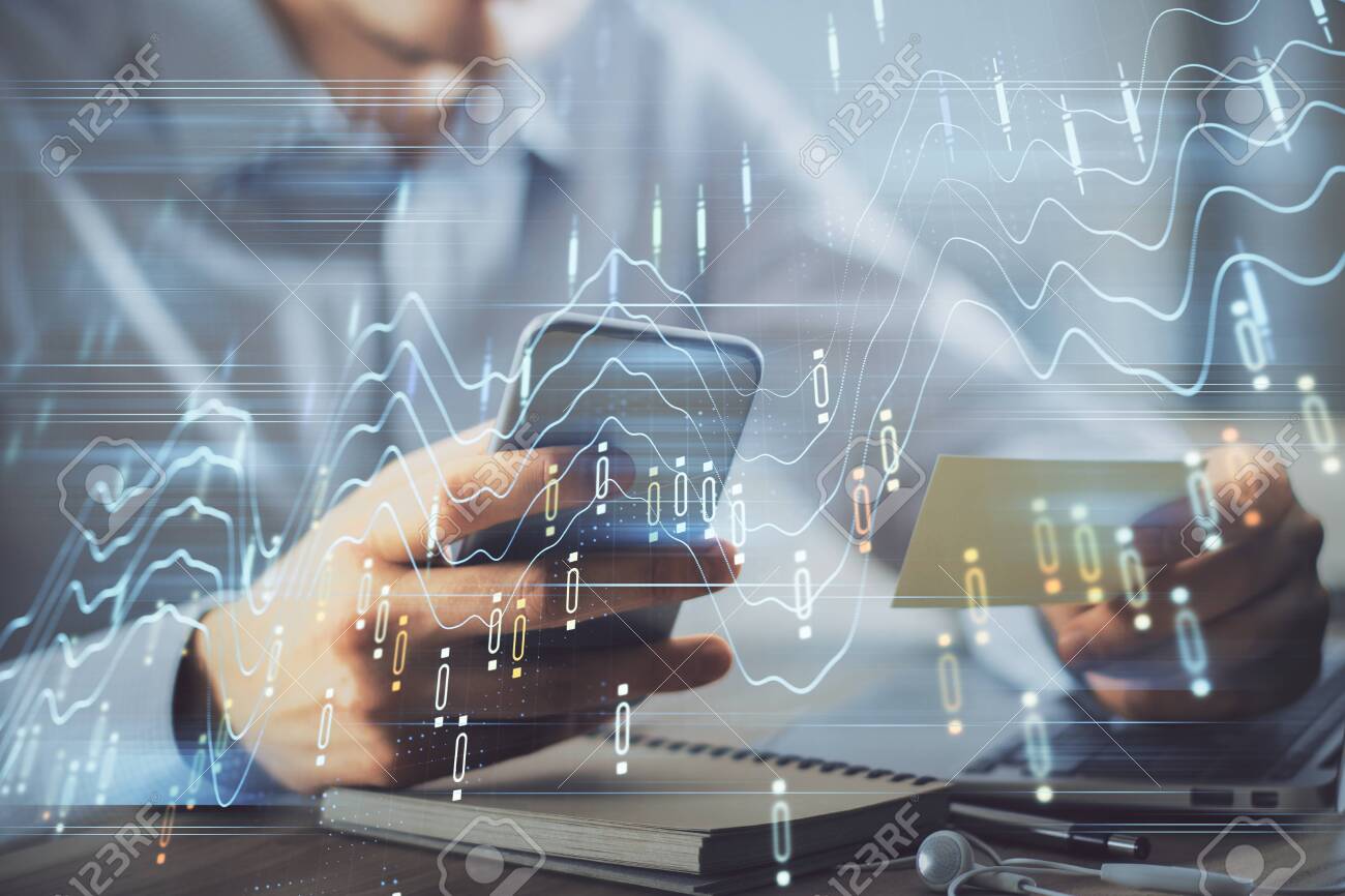 Double exposure of mans hands holding and using a phone and financial graph drawing. Analysis concept. - 150794412 Double exposure of mans hands holding and using a phone and financial graph drawing. Analysis concept. - 150794412