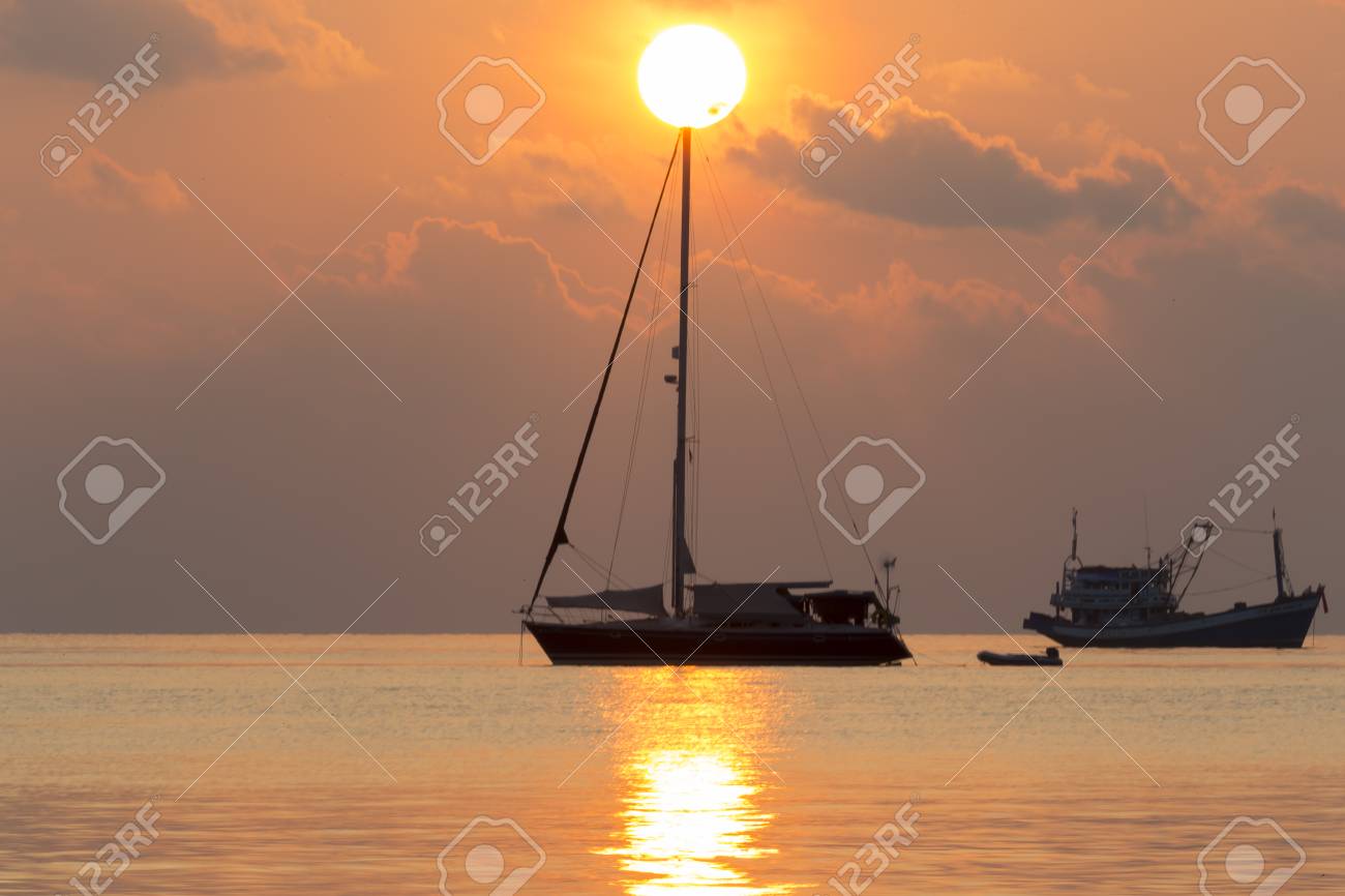 The Beautiful Orange Light Of Sunrise With Boats And Calm Sea Stock Photo Picture And Royalty Free Image Image