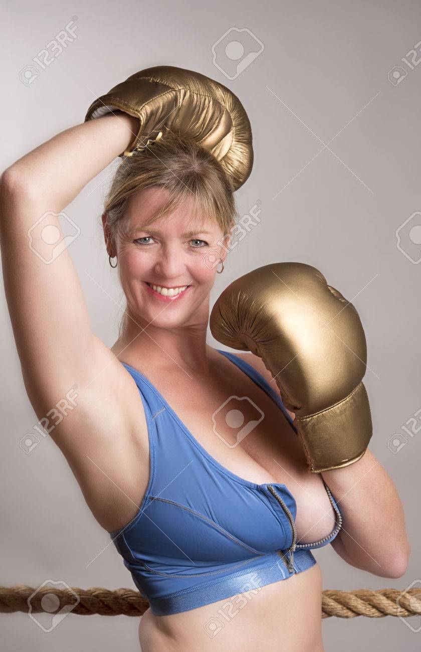 Female Boxer Wearing Gold Coloured Boxing Gloves Stock Photo, Picture and  Royalty Free Image. Image 68192281.