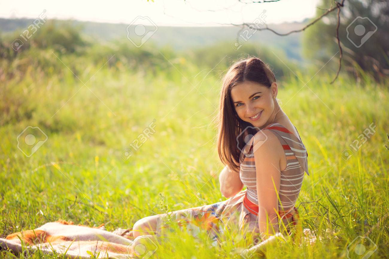 Elegant young smiling woman posing in sunny park - 41791565 Elegant young smiling woman posing in sunny park - 41791565