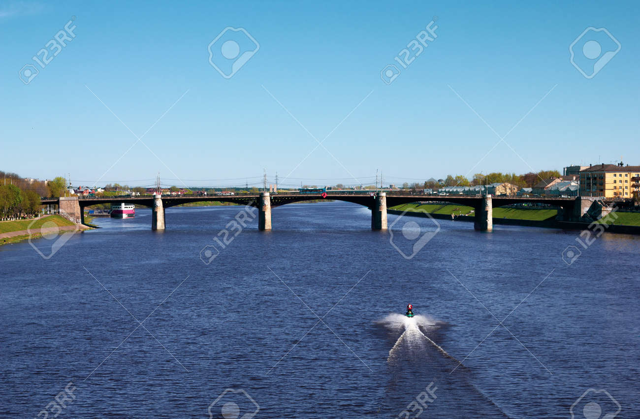 TVER, Russia, May 2021: View of the Novovolzhsky Bridge on the Volga River in Tver. Boat on the Volga. Beautiful river landscape. - 170430021 TVER, Russia, May 2021: View of the Novovolzhsky Bridge on the Volga River in Tver. Boat on the Volga. Beautiful river landscape. - 170430021