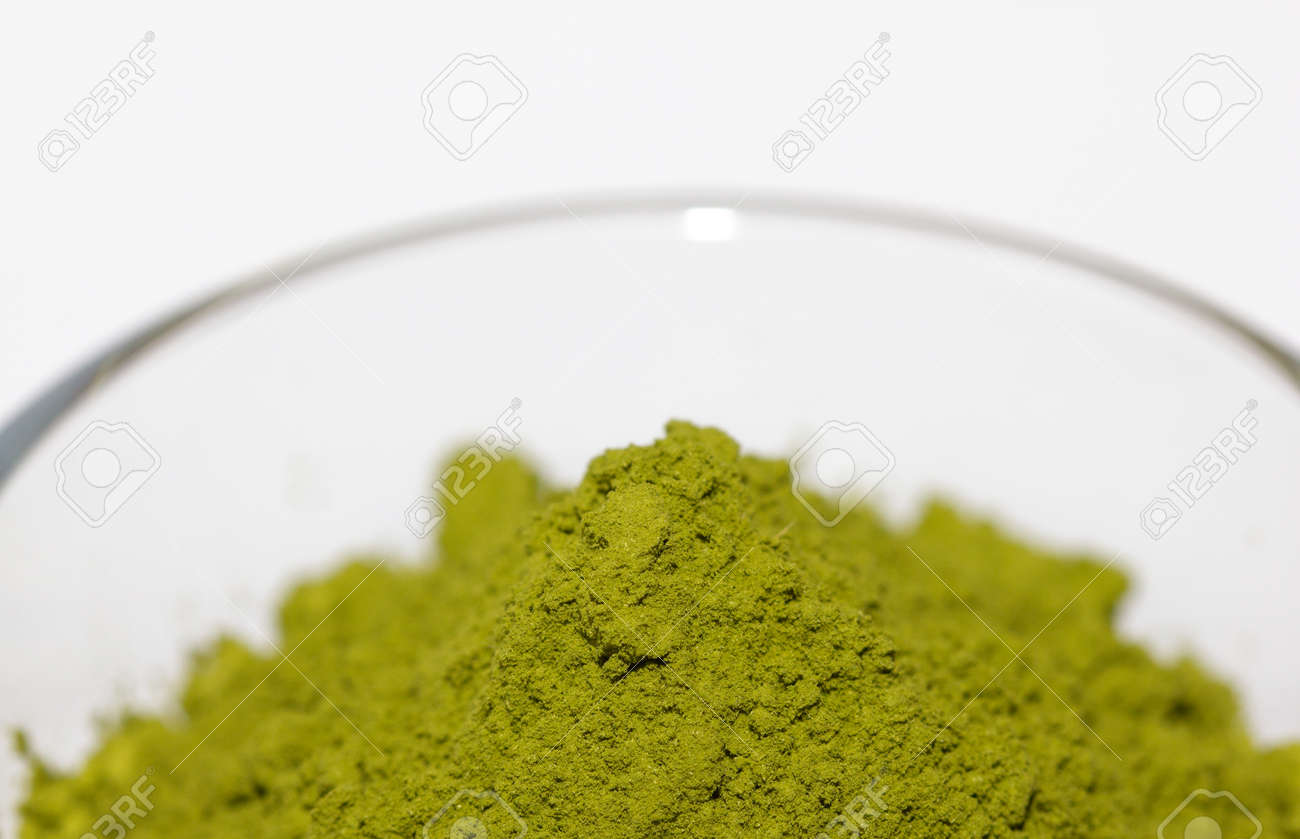 Powdered green matcha tea on a white isolated background close-up. Texture of matcha tea macro background. Copy space. Top view. Flat lay. - 170430095 Powdered green matcha tea on a white isolated background close-up. Texture of matcha tea macro background. Copy space. Top view. Flat lay. - 170430095
