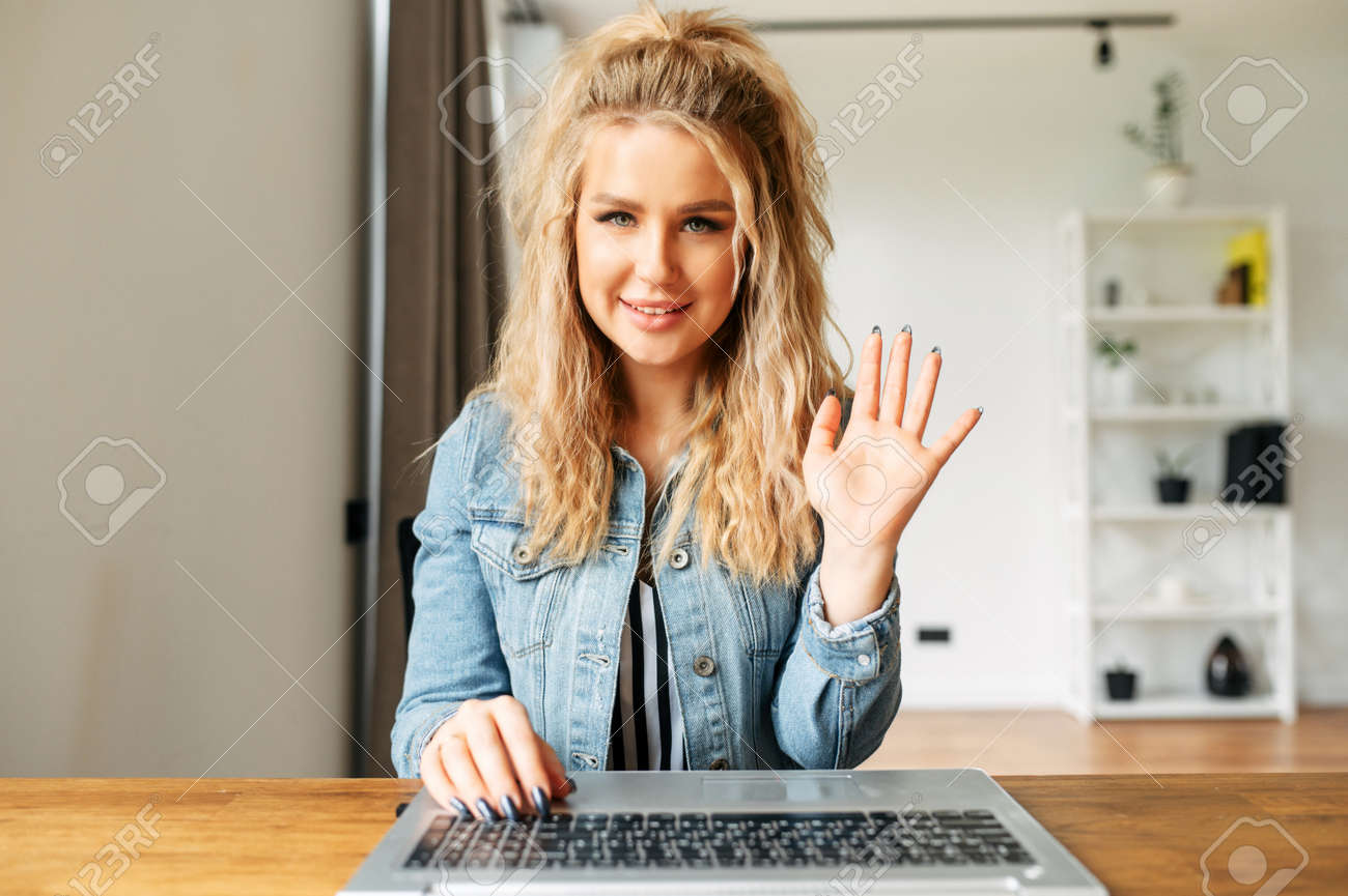 Video Chatting With Cheerful Pretty Girl. Webcam Shot Of Blonde Young  Woman, She Waving Hello Into Webcam Stock Photo, Picture and Royalty Free  Image. Image 148346376.