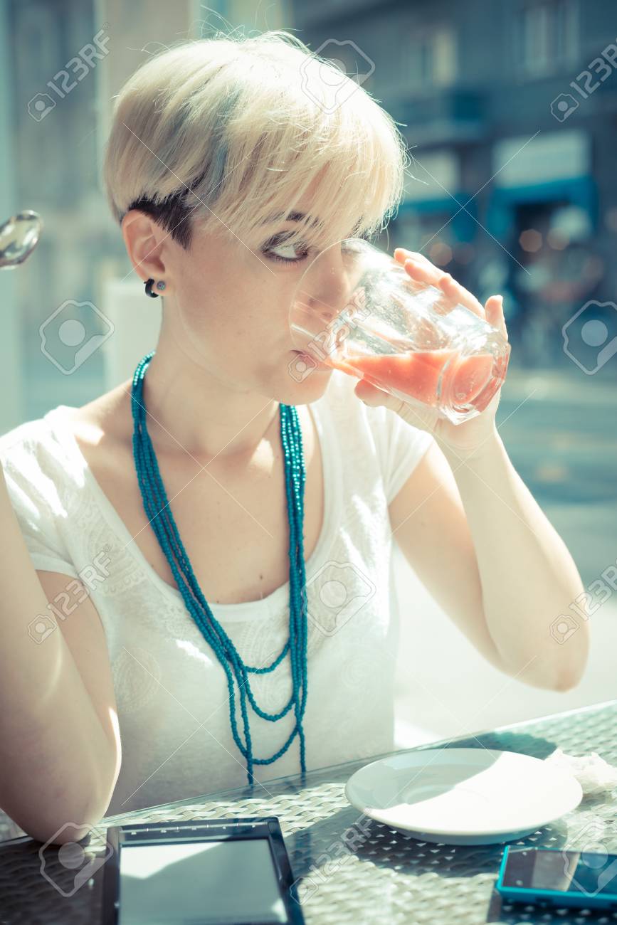 Beautiful Young Blonde Short Hair Hipster Woman At The Cafe Stock