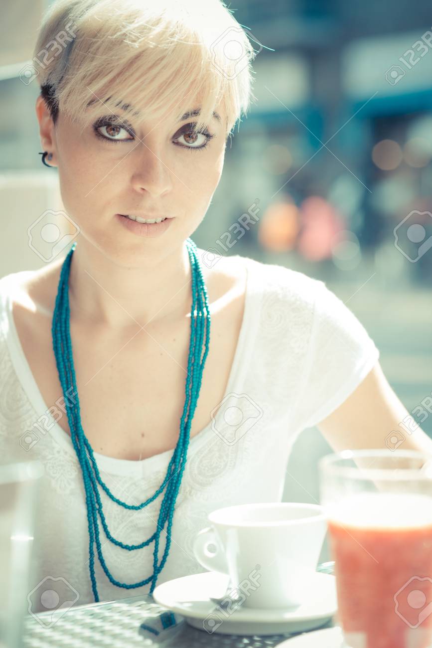 Beautiful Young Blonde Short Hair Hipster Woman At The Cafe Stock