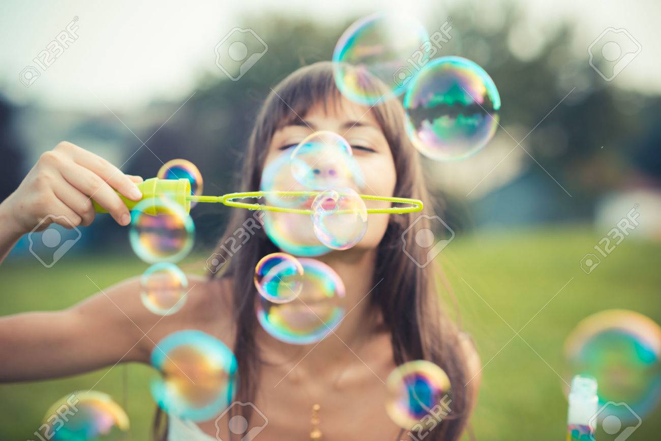 Beautiful Young Woman With White Dress Blowing Bubbles Stock Photo ...