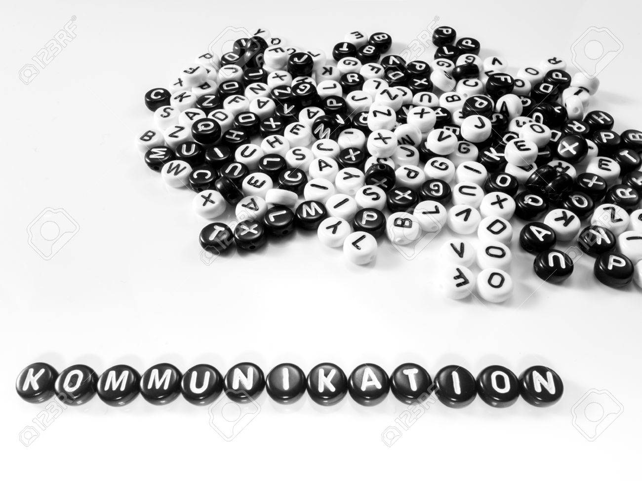 heap of round letters black and white and communication word written in german written by side; kommunikation - 55371378 heap of round letters black and white and communication word written in german written by side; kommunikation - 55371378