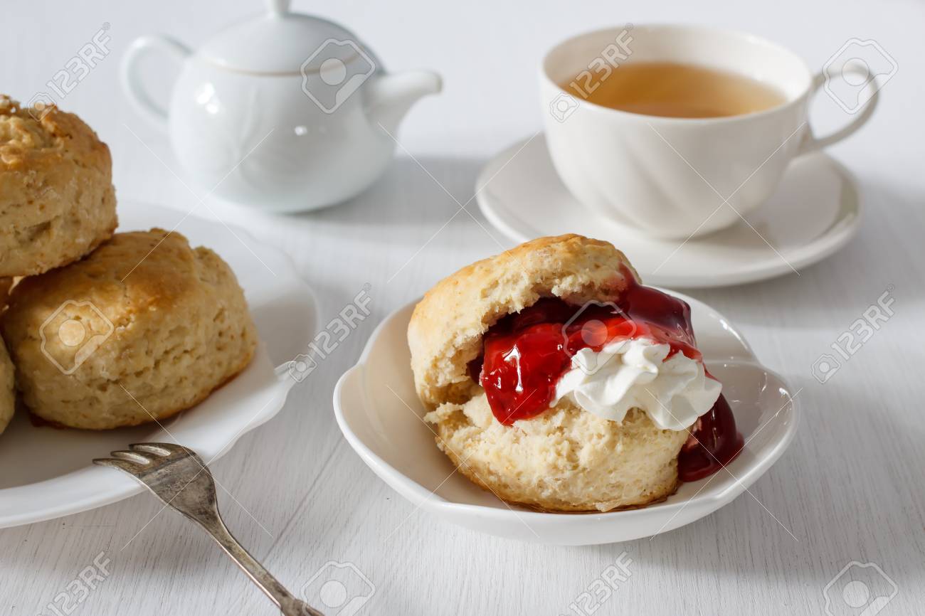 クロテッドクリーム イチゴジャム 紅茶を添えた伝統的な英国のスコーン の写真素材 画像素材 Image