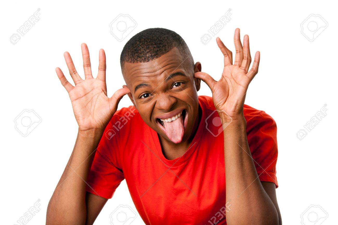 Young Man With Humorous Funny Expression Sticking Tongue Out And ...