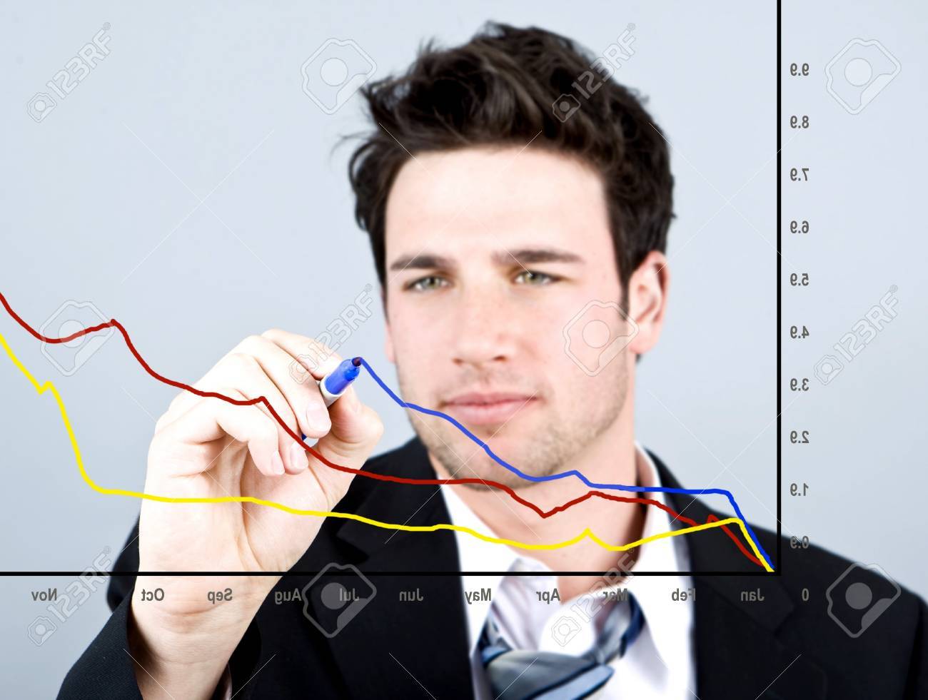 Attractive business man drawing on a graph - 4408779 Attractive business man drawing on a graph - 4408779