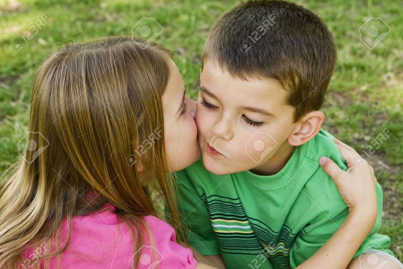 Sister giving her brother a kiss on the cheek - 4925725 Sister giving her brother a kiss on the cheek - 4925725