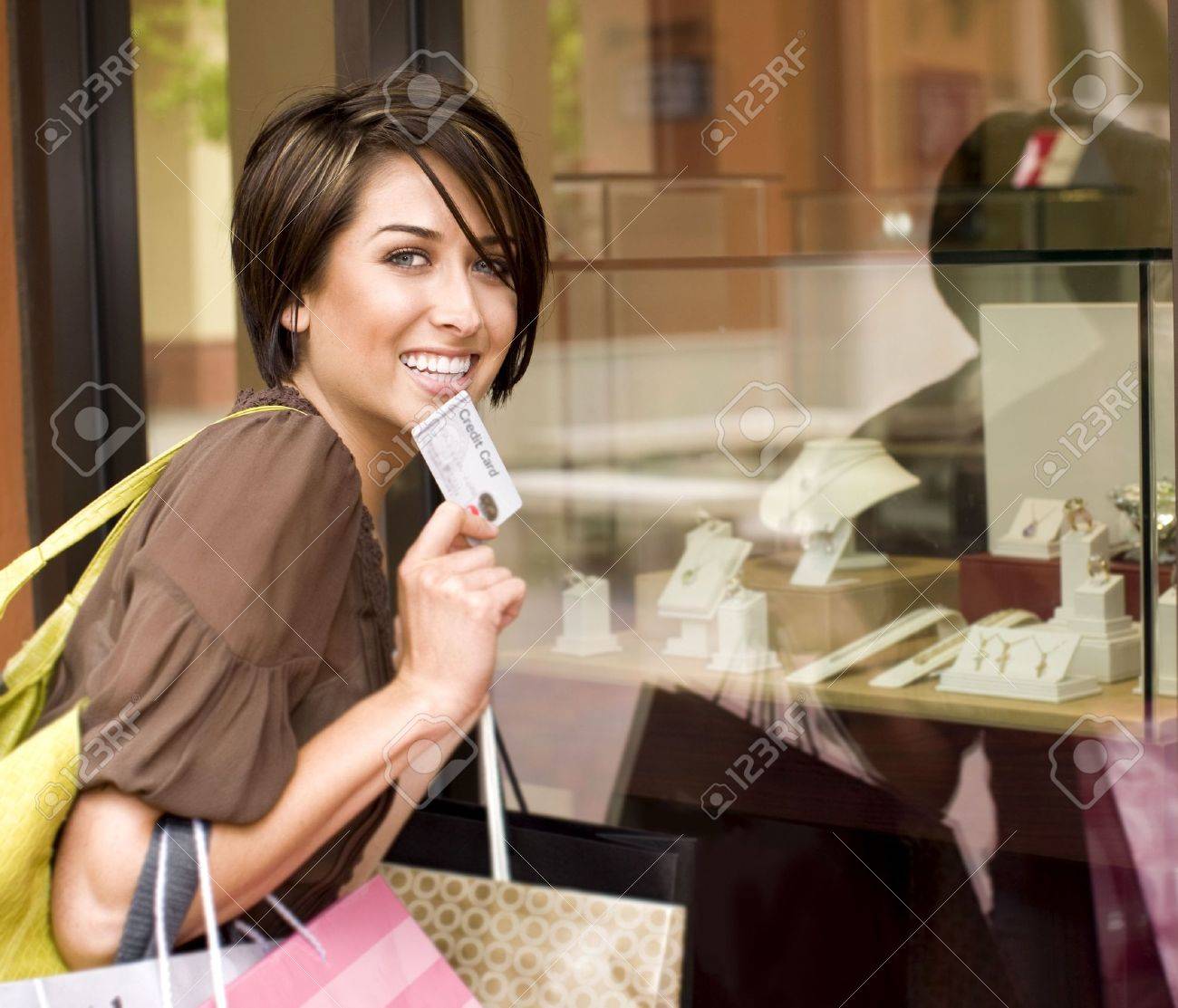 Happy woman shopping with her credit card - 5047209 Happy woman shopping with her credit card - 5047209