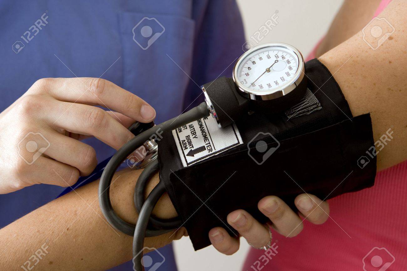 Doctor or nurse taking a patient's blood pressure - 5132633 Doctor or nurse taking a patient's blood pressure - 5132633