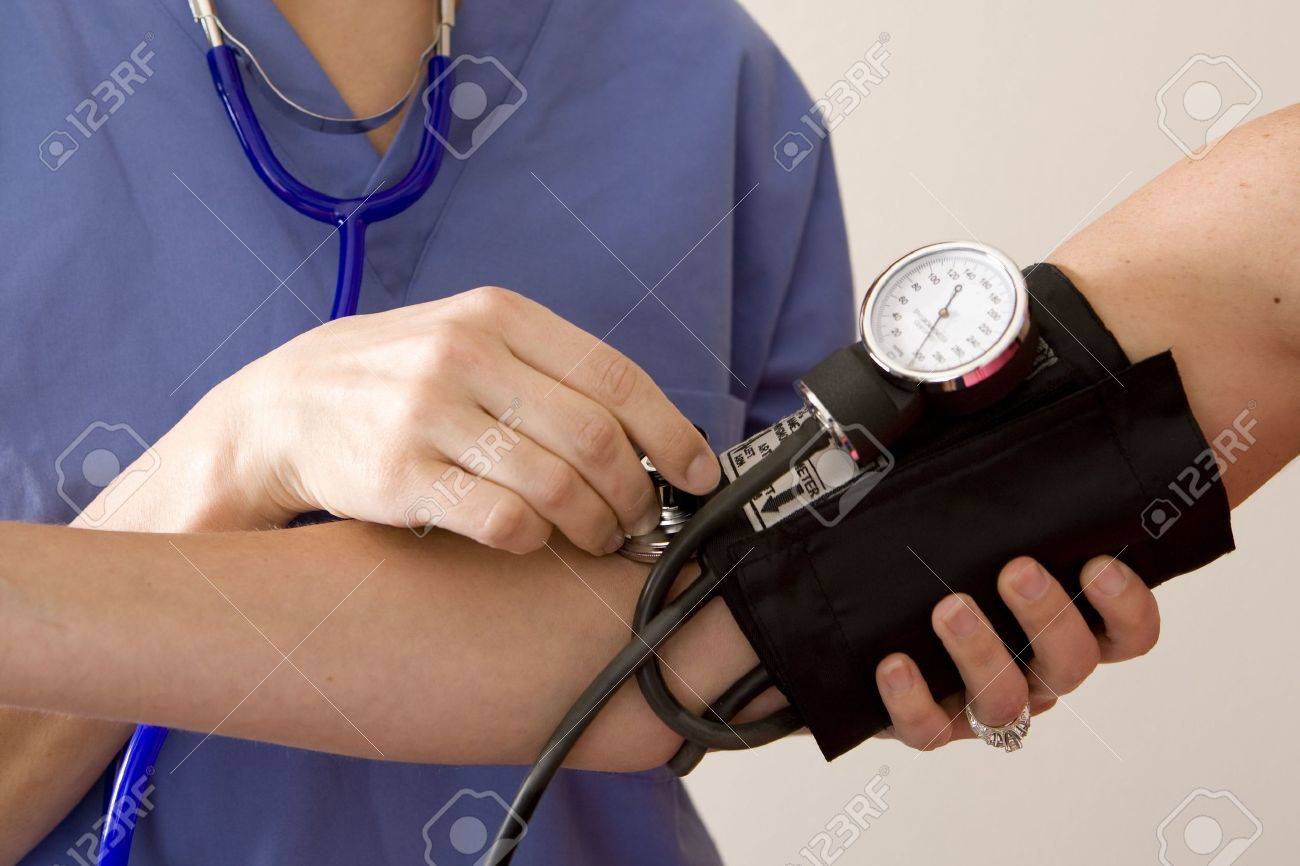 Doctor or nurse taking a patient's blood pressure - 5201010 Doctor or nurse taking a patient's blood pressure - 5201010