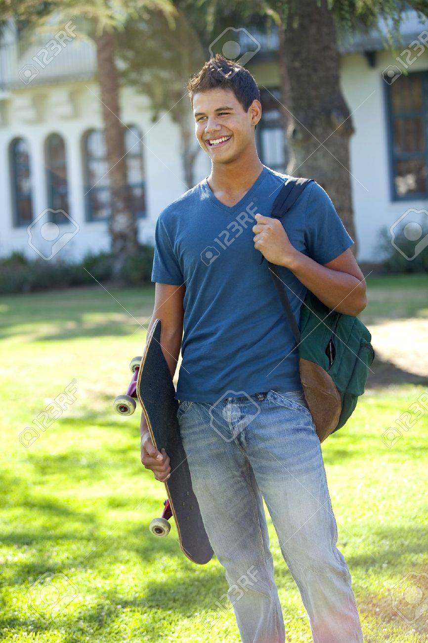 Student with skateboard and backpack outside school - 8671702 Student with skateboard and backpack outside school - 8671702