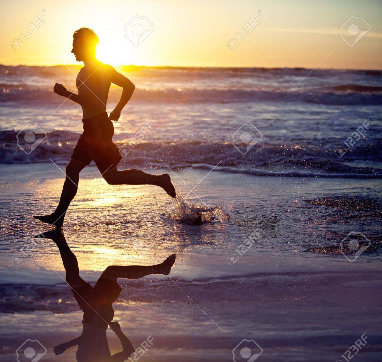 Man running on the beach at sunset - 18304534 Man running on the beach at sunset - 18304534
