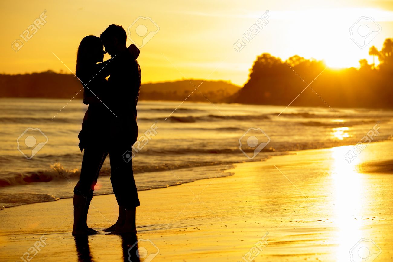 Silhouette of a couple on the beach at sunset - 31905886 Silhouette of a couple on the beach at sunset - 31905886
