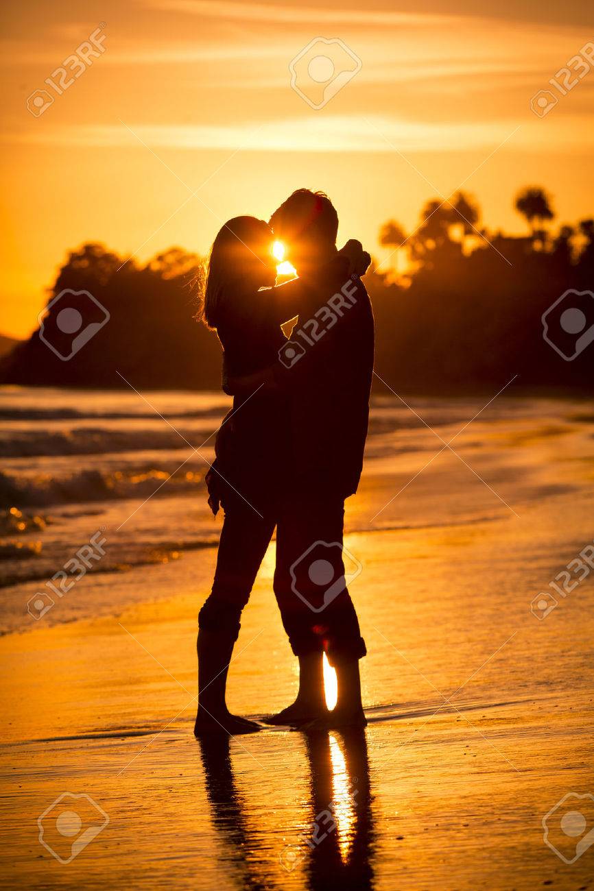 Silhouette of a couple on the beach at sunset - 31905118 Silhouette of a couple on the beach at sunset - 31905118