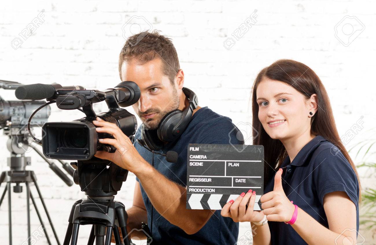 a cameraman and a young woman with a movie camera - 44504998 a cameraman and a young woman with a movie camera - 44504998