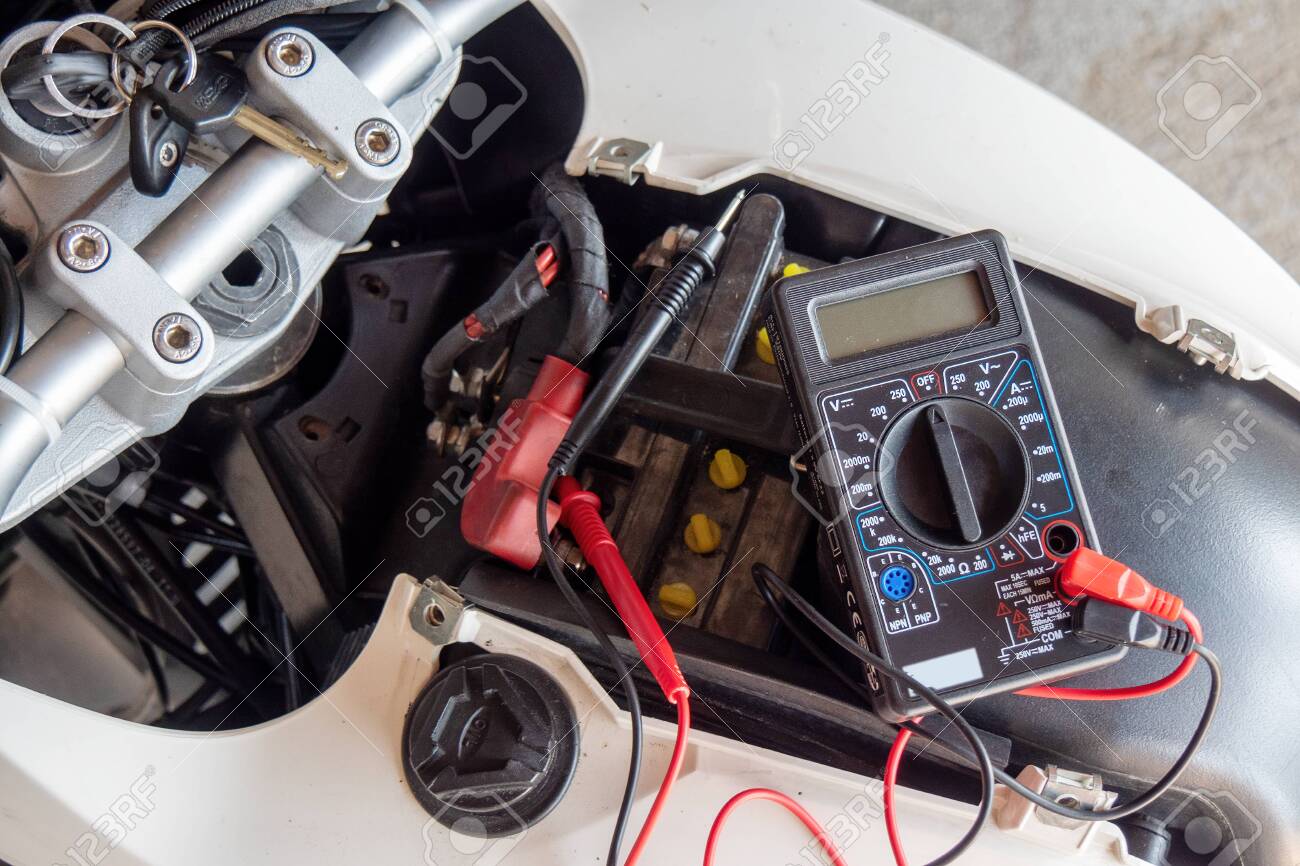 a check volt of battery with motorcycle service concept - 156757654 a check volt of battery with motorcycle service concept - 156757654