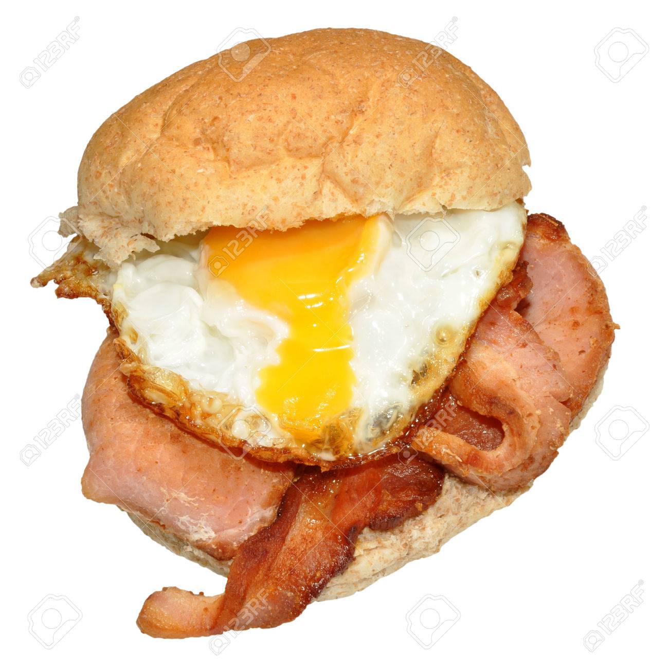 Fried Egg And Bacon On A Wholemeal Bread Roll Isolated On A