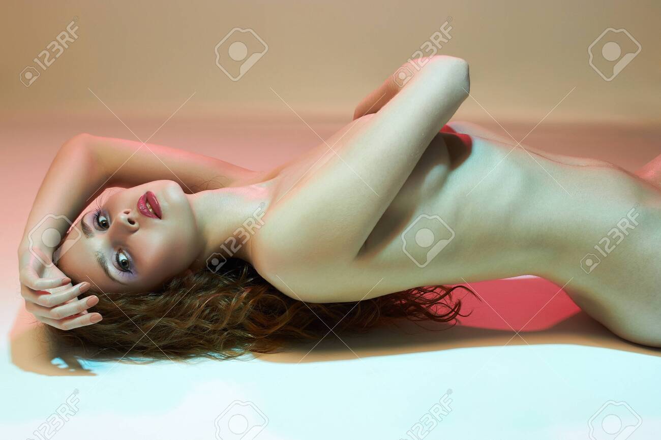 Beautiful Naked Girl In Color Lights. Nude Perfect Body Young Woman On The  Floor Stock Photo, Picture and Royalty Free Image. Image 152750683.