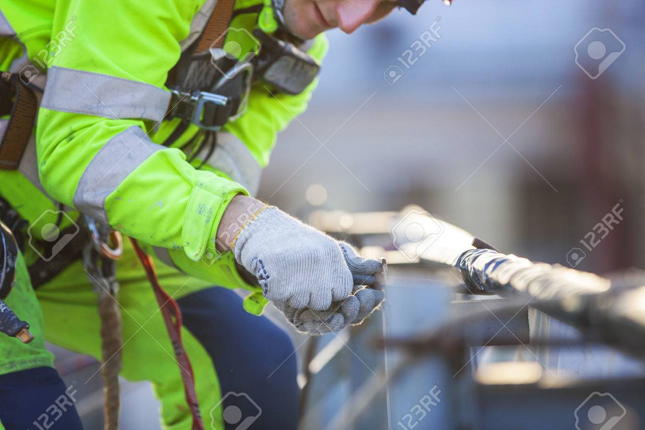 Closeup of industrial climber working on roof of building - 39246718 Closeup of industrial climber working on roof of building - 39246718