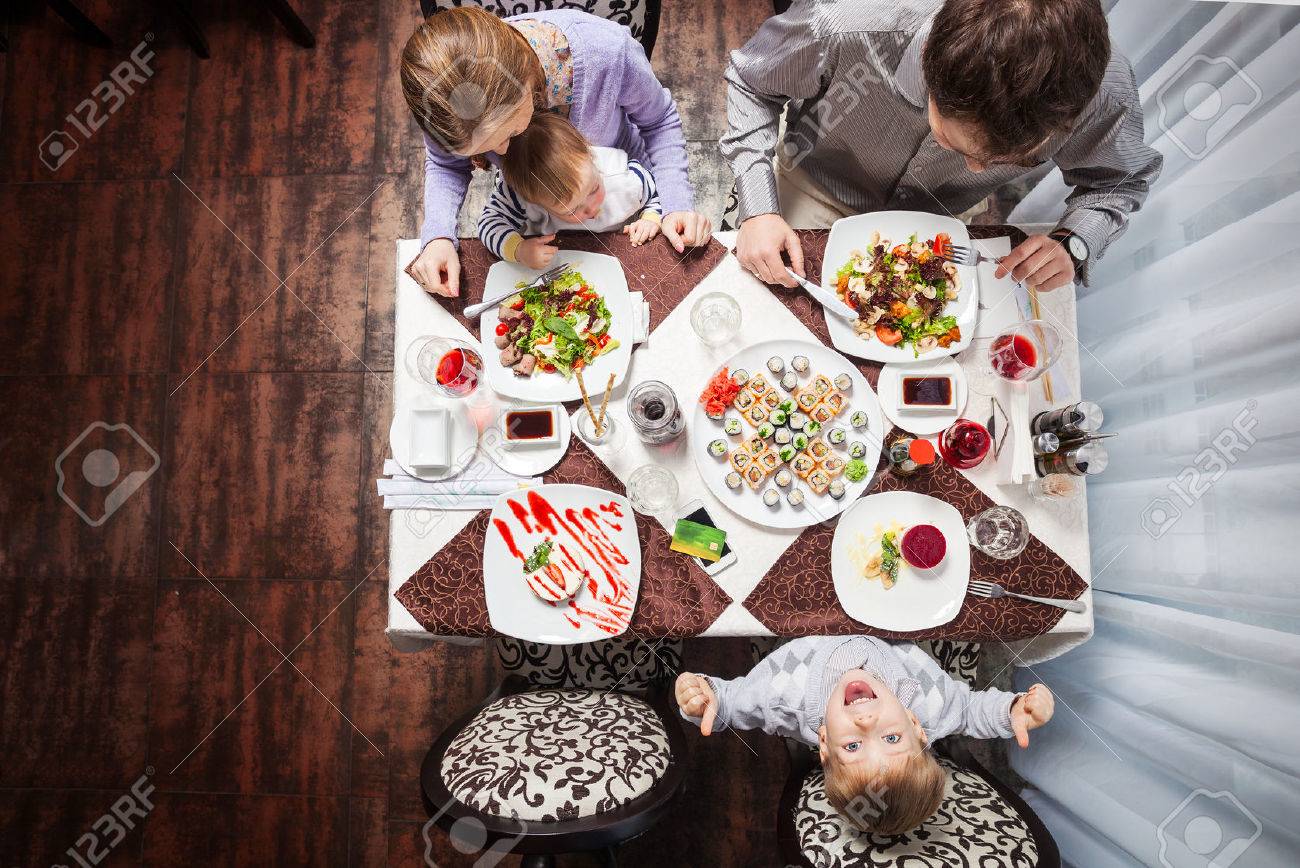 Family of four having meal at a restaurant - 55686768 Family of four having meal at a restaurant - 55686768