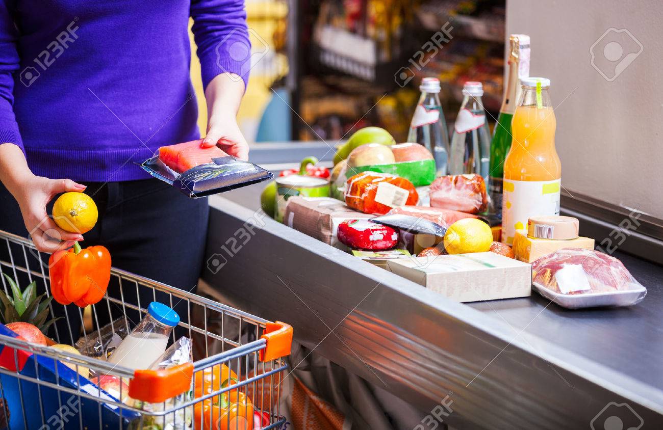 Young couple before checkout in supermarket - 55687369 Young couple before checkout in supermarket - 55687369