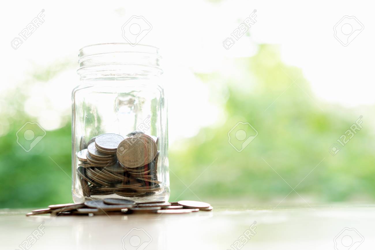 savings word with money coin in glass jar financial concept stock word with jar