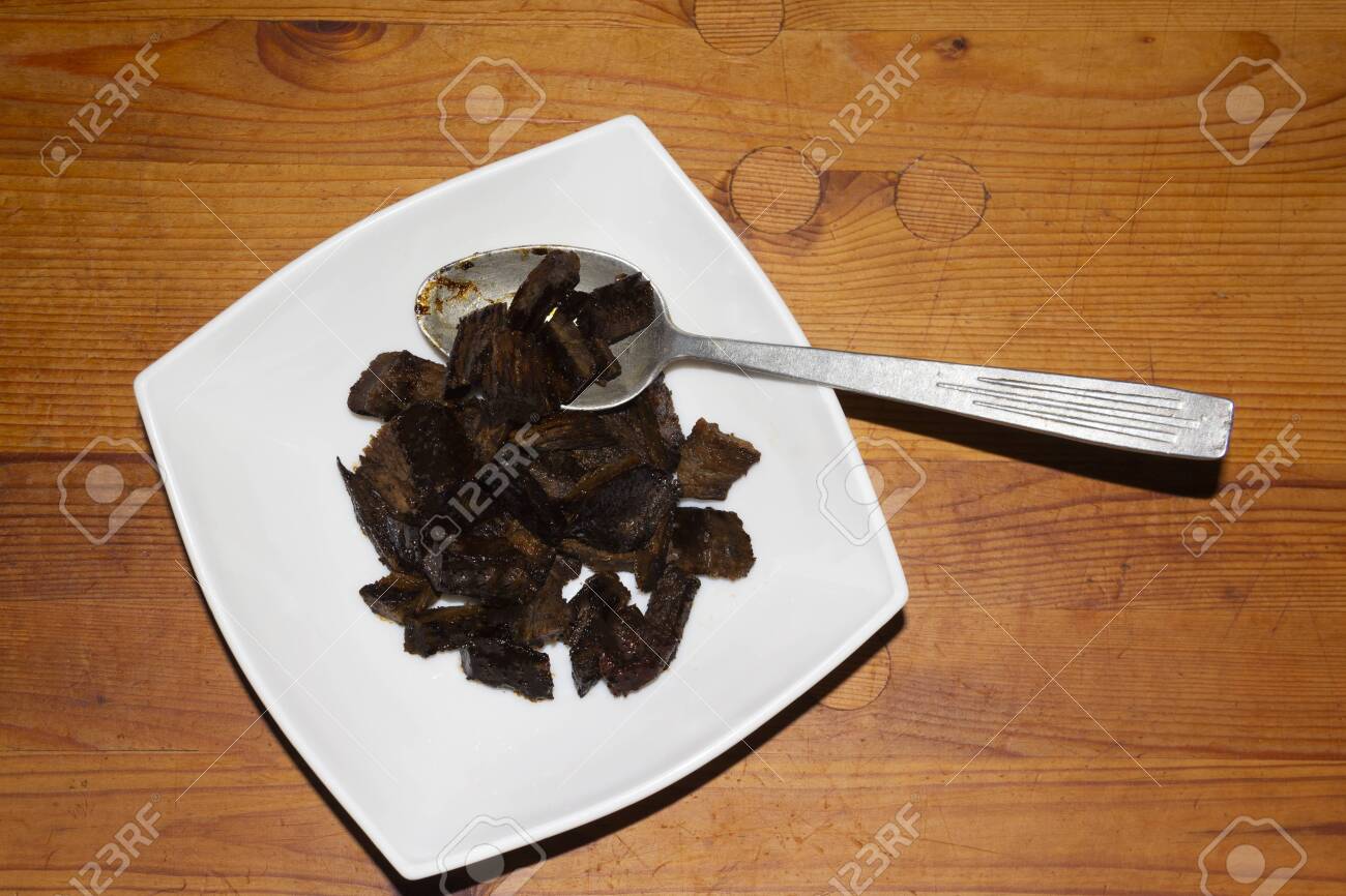 Pieces Of Burnt Meat On A Plate Inedible Food Wooden Rustic Stock Photo Picture And Royalty Free Image Image